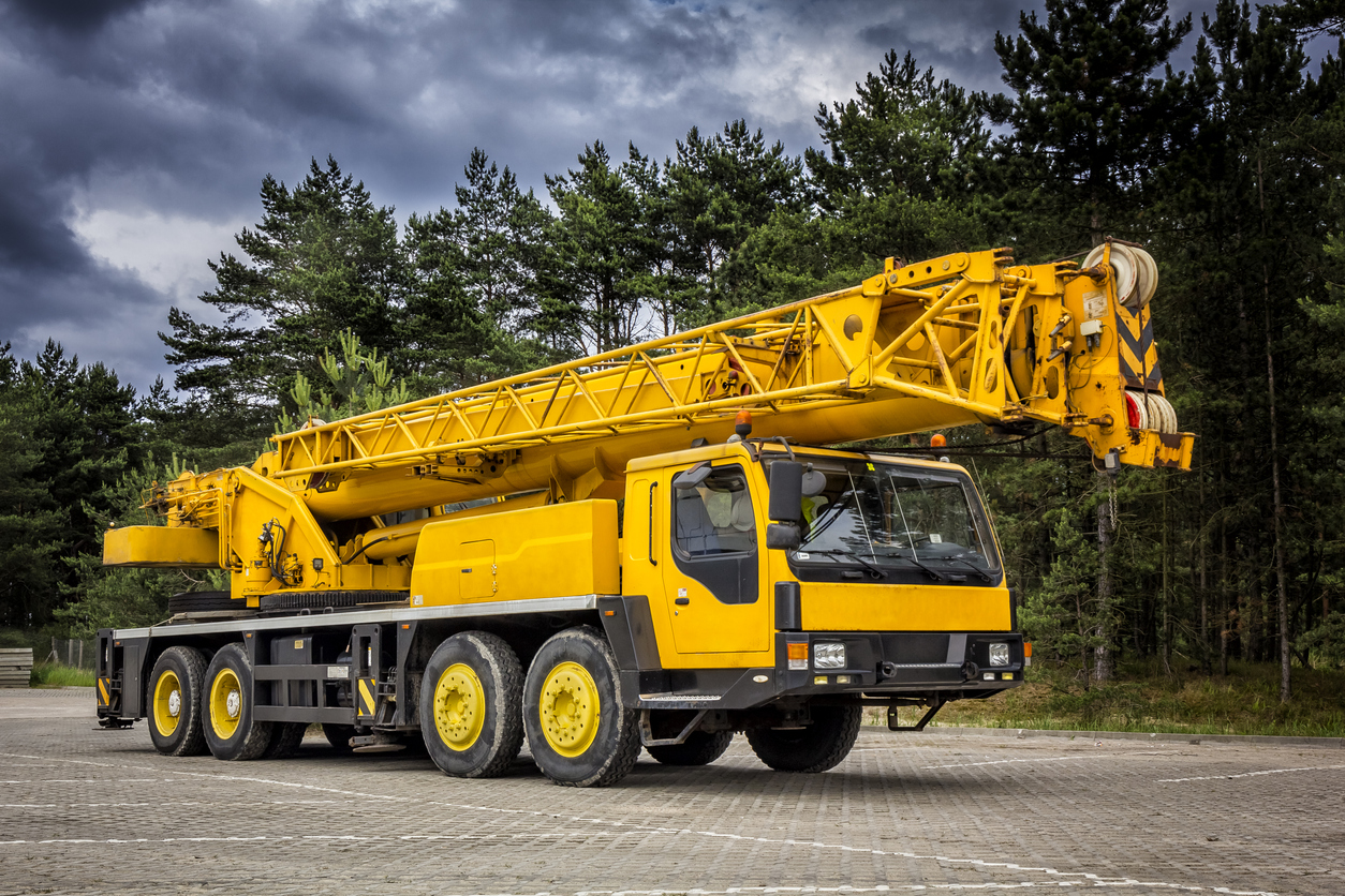 Yellow mobile crane in road construction